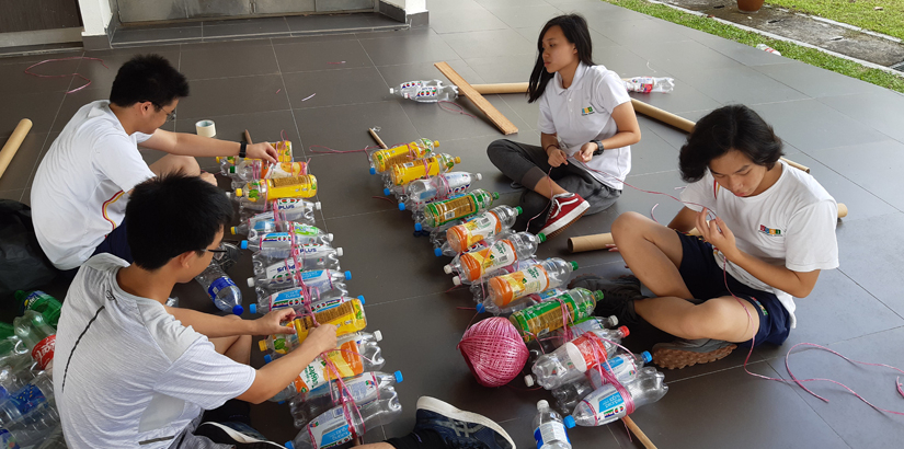 DP students building raft using used plastic bottles for the Group 4 project (Sciences).